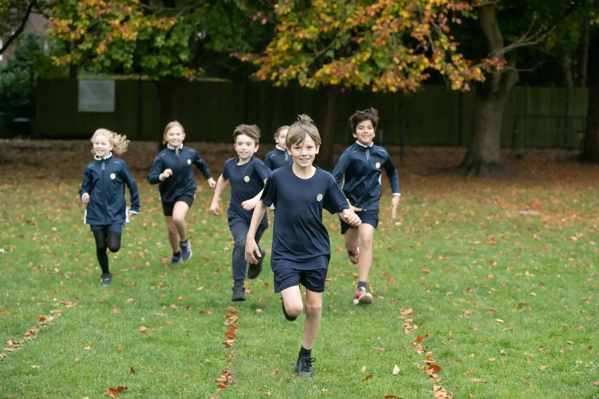 Pupils at Gorsey Bank Primary School run on the field.